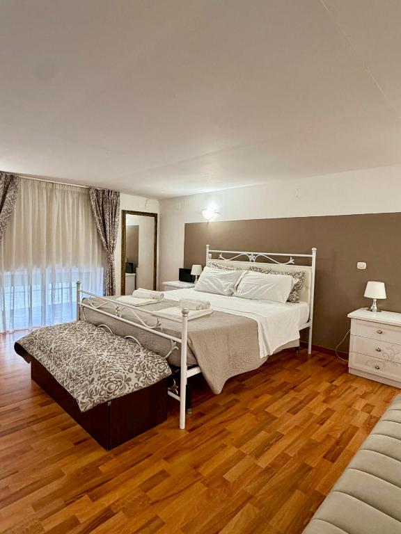 a bedroom with a large bed and a couch at Casa Bella - Ortigia & Neapolis in Syracuse
