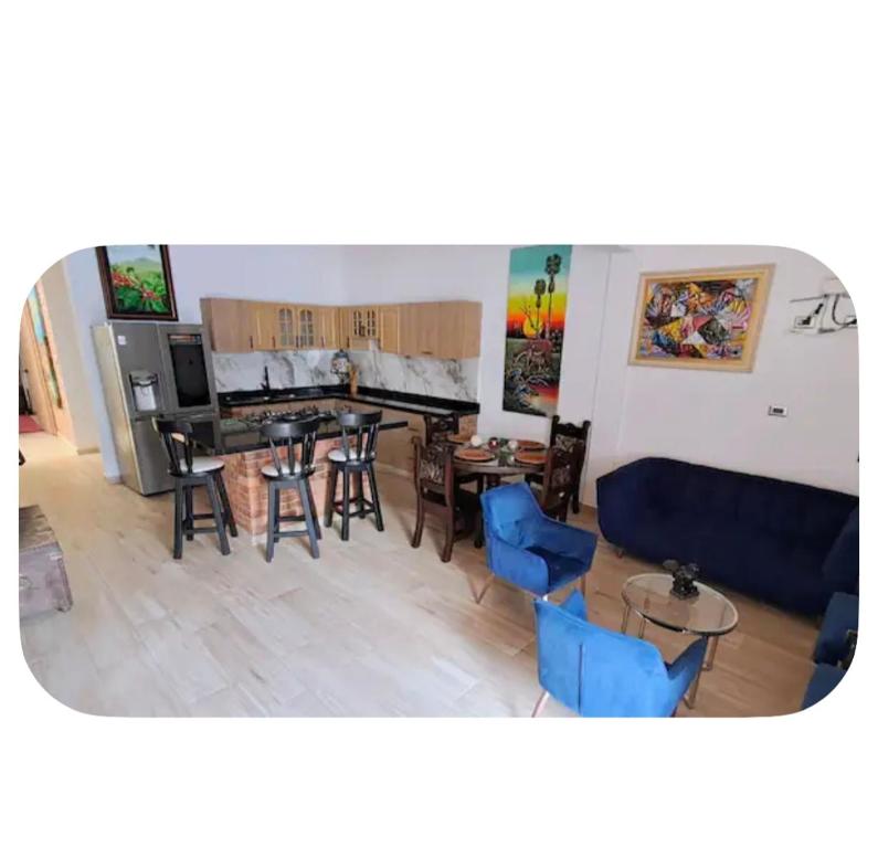 a living room with a couch and a table and chairs at Casa amoblada in Yopal