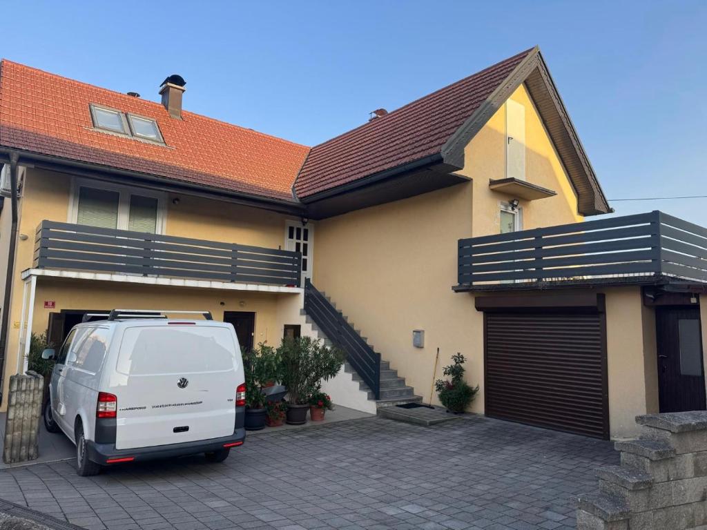 a white van parked in front of a house at Apartment Sawetz - Ptuj in Ptuj