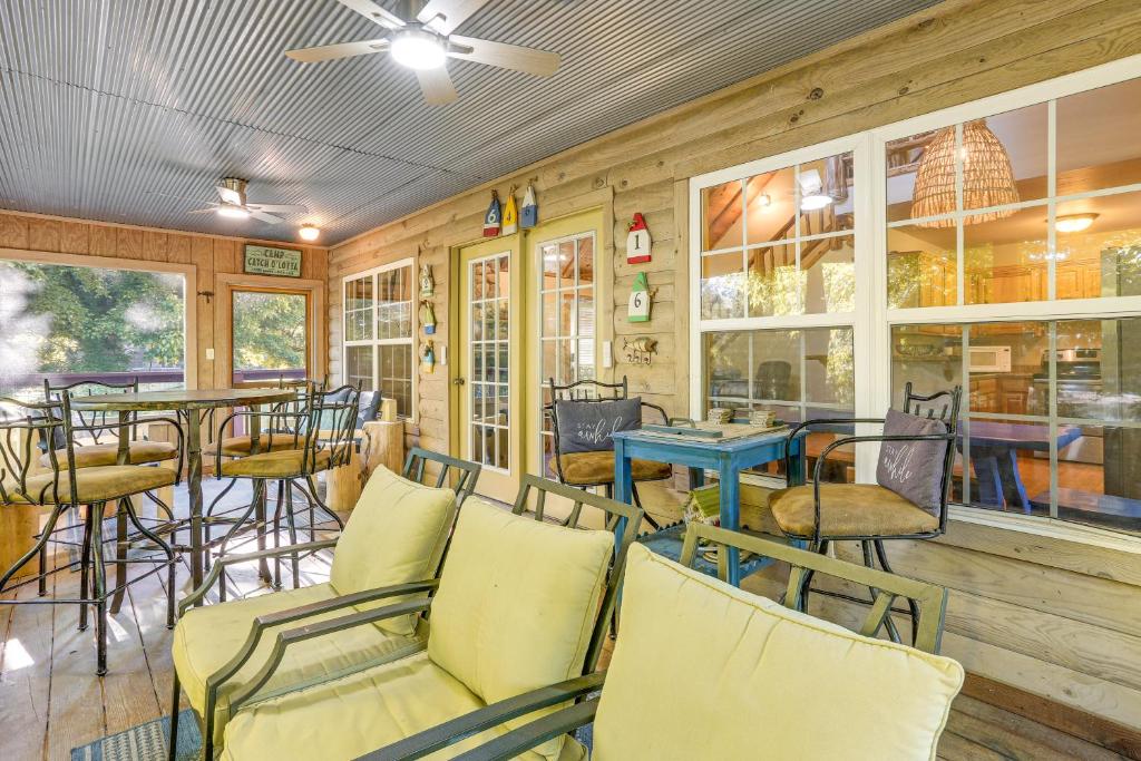 a restaurant with chairs and tables and windows at Secluded White River Haven! 4 Mi to Devil's Knob in Melbourne