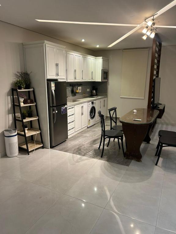 a kitchen and dining room with a table and chairs at شاليهات موج لاند 1 in Taif