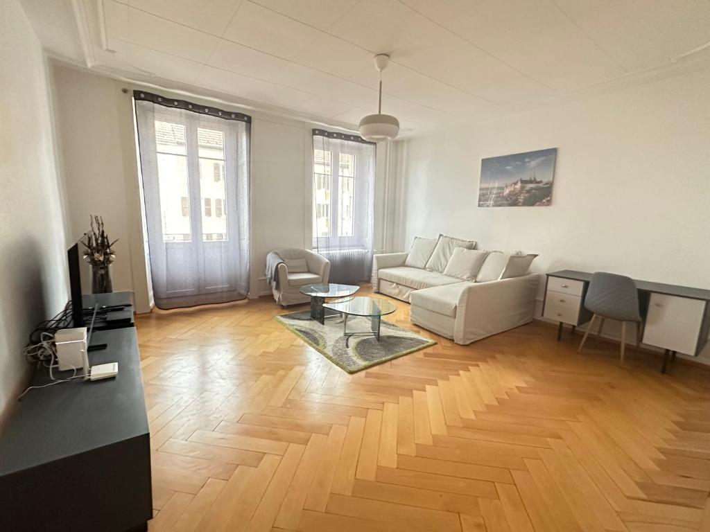 a living room with a couch and a table at Abeilles in La Chaux-de-Fonds