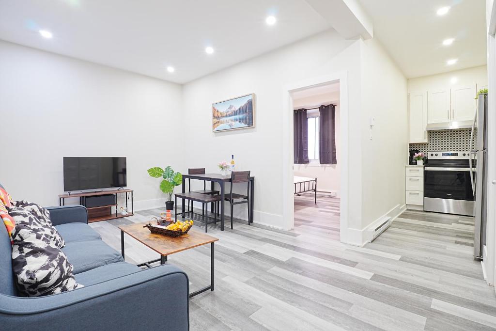 a living room with a blue couch and a table at Cozy stays in Montreal