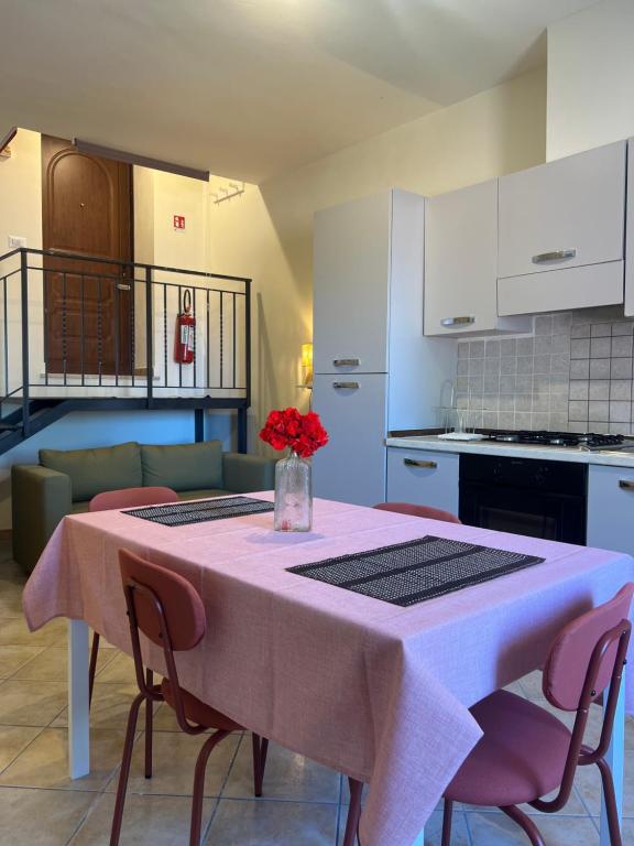 a kitchen with a table with a vase of flowers on it at Casa Bellini in Gallinaro