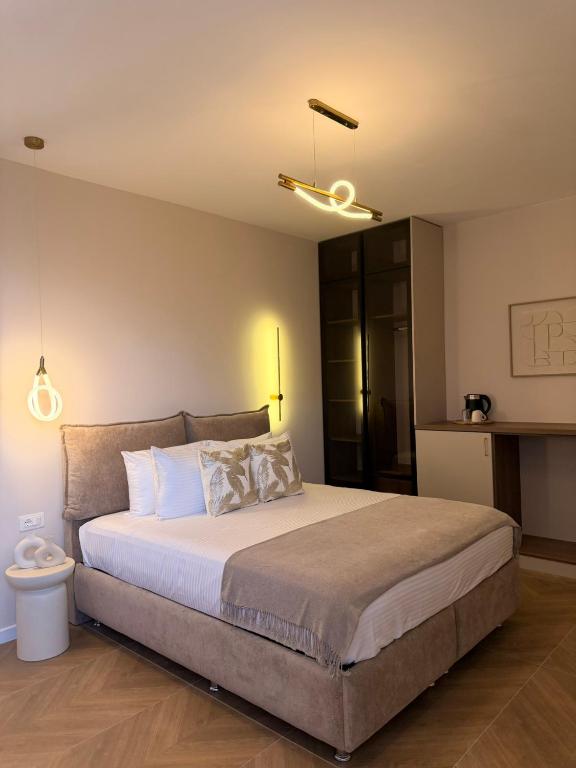 a bedroom with a large bed with white pillows at MD APARTMENTS in Ulcinj