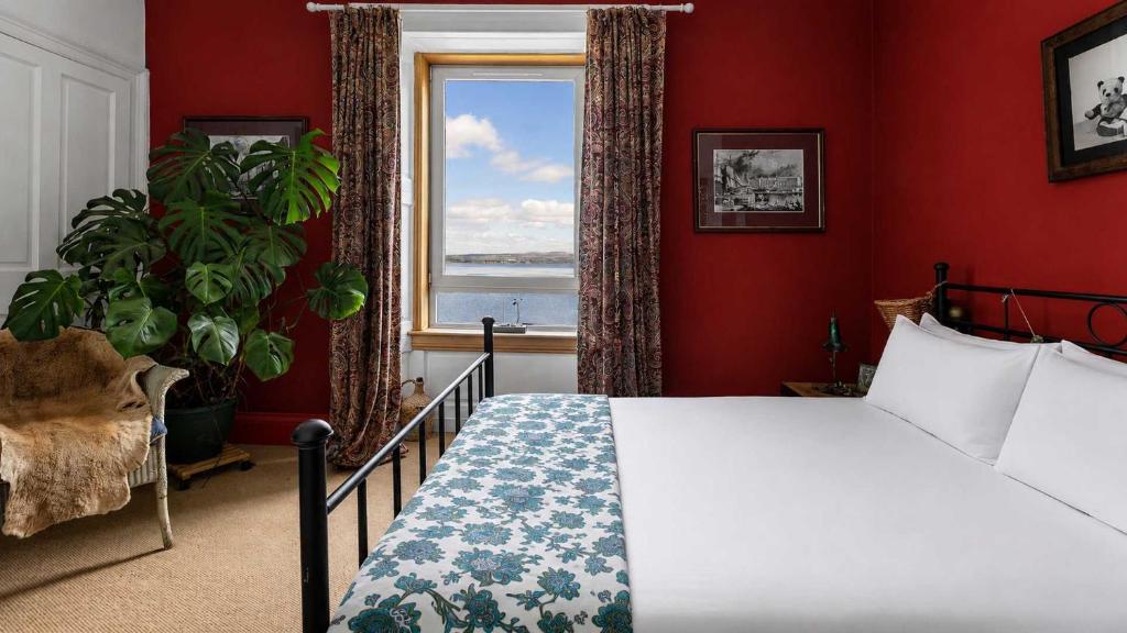 a bedroom with a large bed and a window at Williams Haven in Rothesay