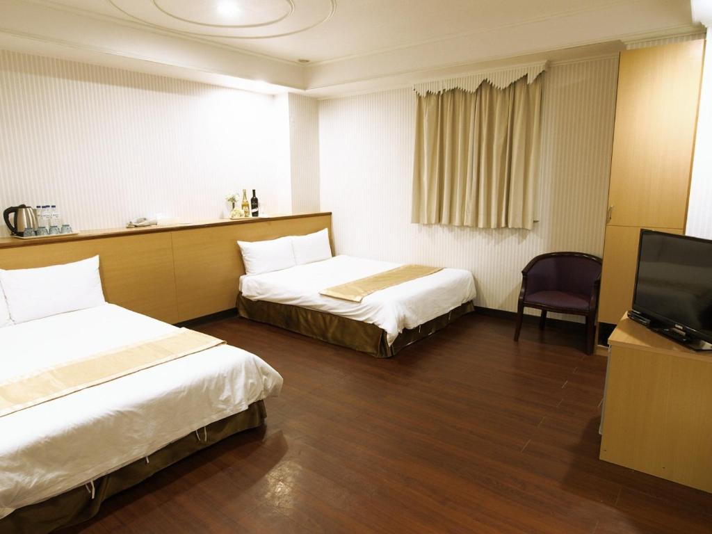 Postel nebo postele na pokoji v ubytování Yi Pin Yuan Hotel