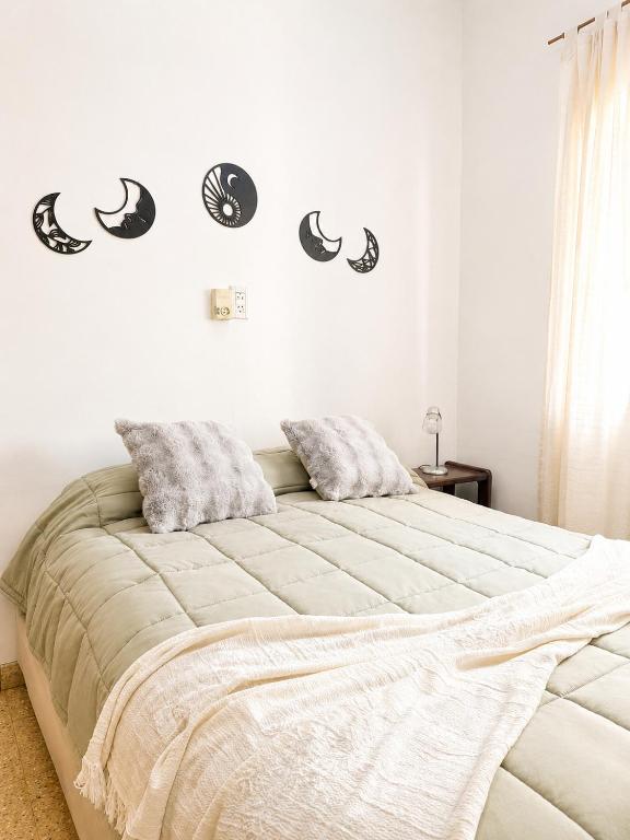a bedroom with a bed with black and white stickers on the wall at Alojamiento Uruguay in Santa Rosa