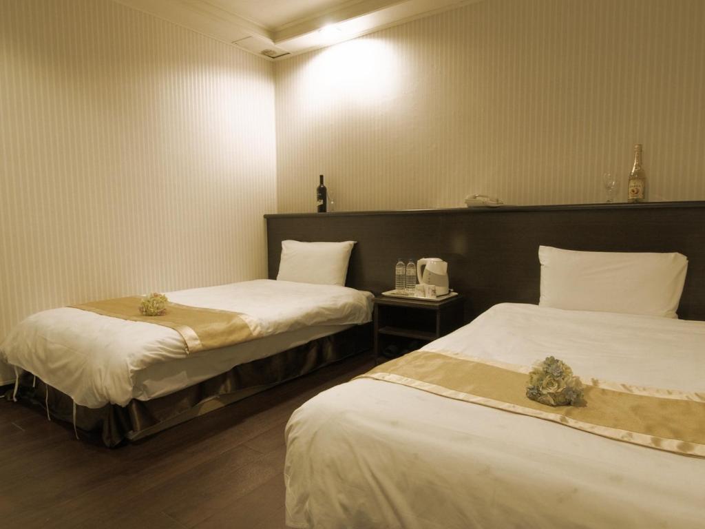 Postel nebo postele na pokoji v ubytování Yi Pin Yuan Hotel