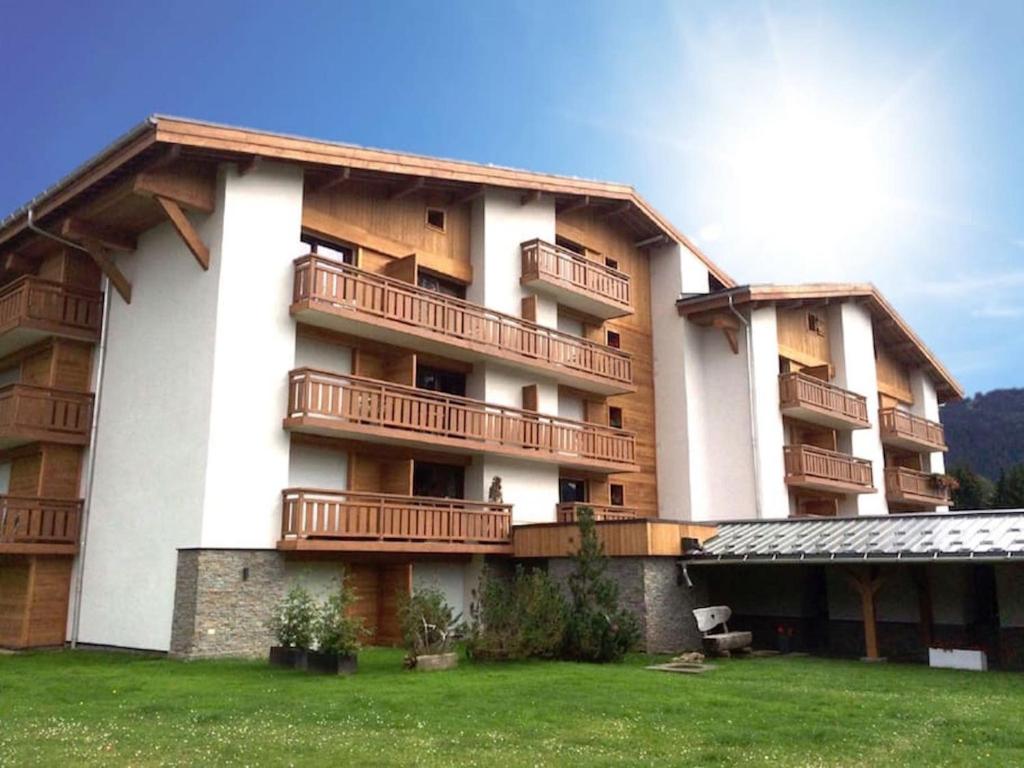 a large building with balconies on the side of it at Résidence Hôtel Rent - Megève in Megève