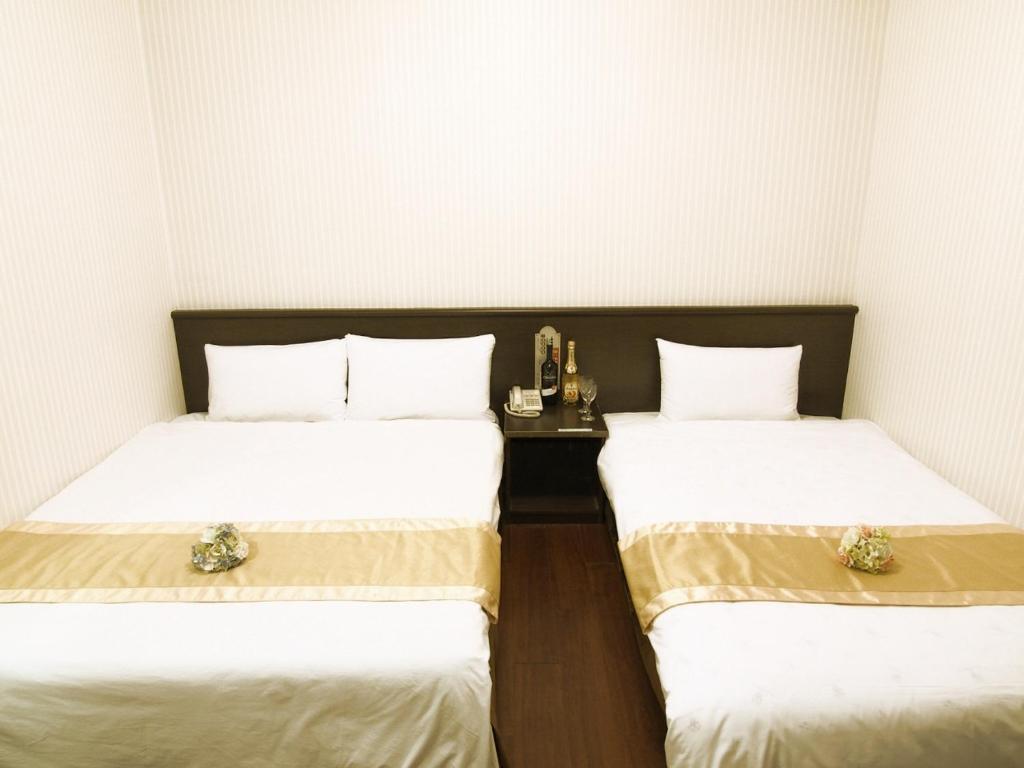 Postel nebo postele na pokoji v ubytování Yi Pin Yuan Hotel