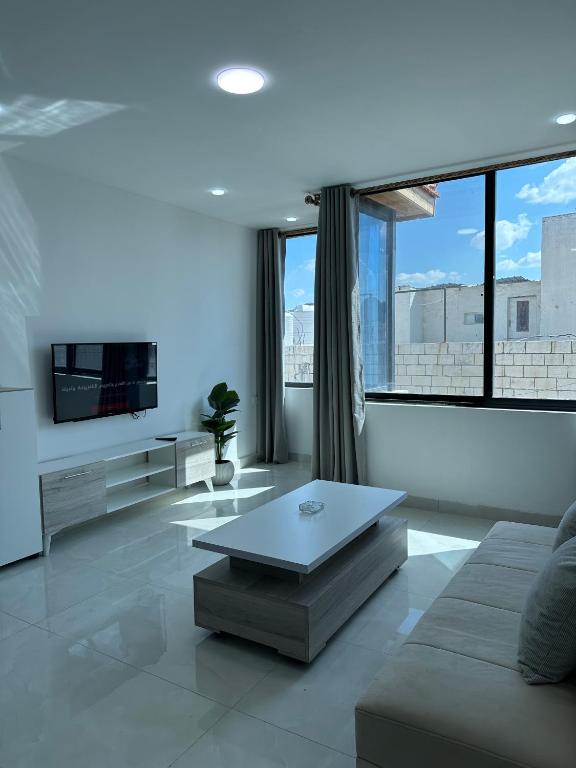 a living room with a couch and a coffee table at Amman Suites in Amman