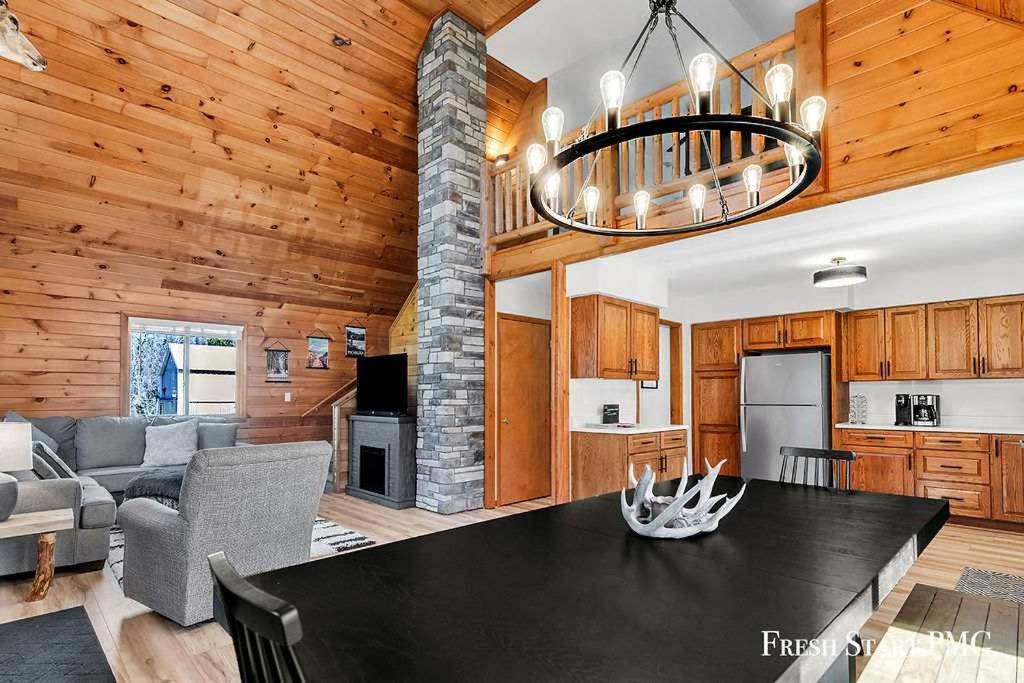 a kitchen and living room with a black table in a house at Cabin in Wellston in Wellston
