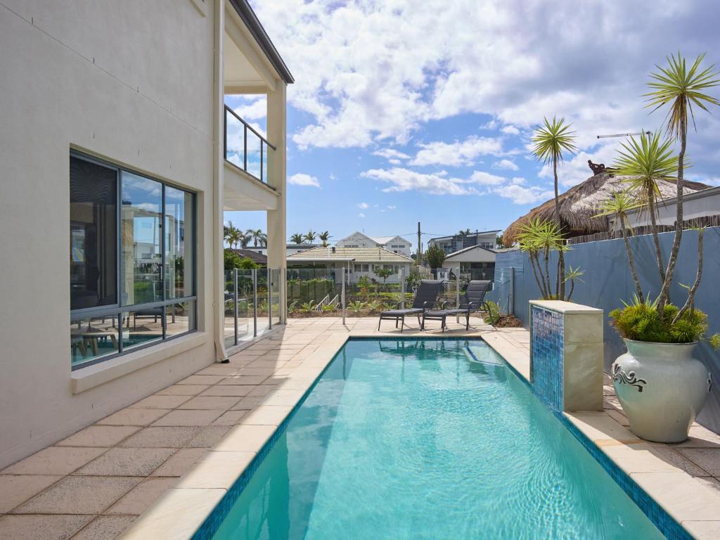 a swimming pool in the backyard of a house at Oasis By Khove - Broadbeach Waters in Gold Coast