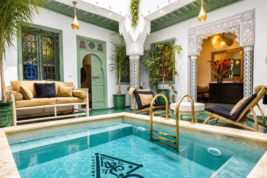 a house with a swimming pool and a living room at Riad Dar Najwa in Marrakesh