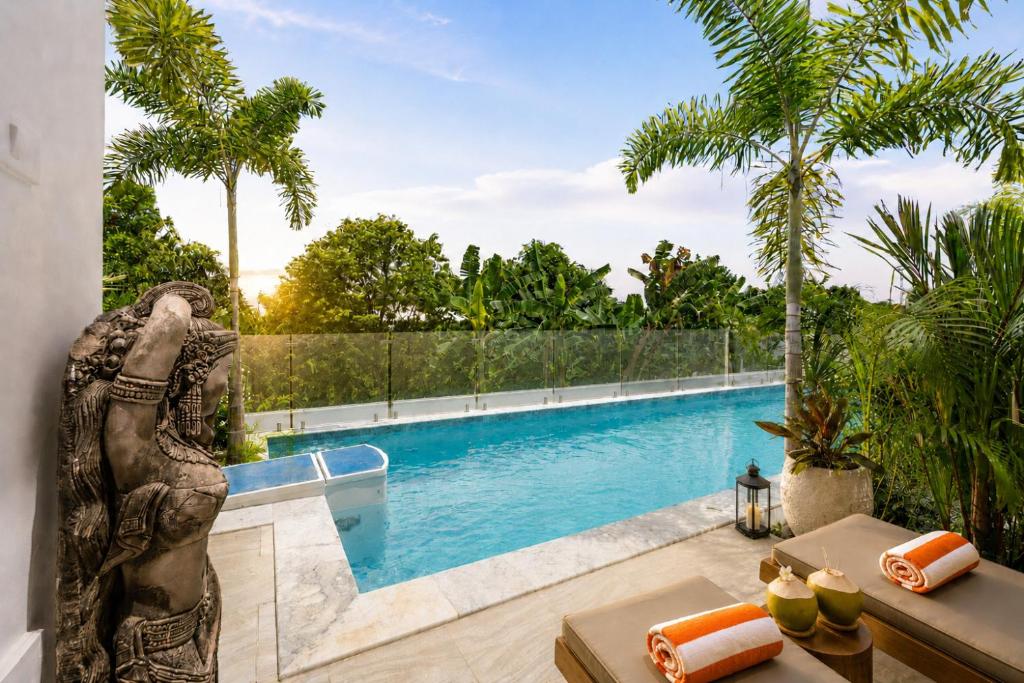 a statue of an elephant standing next to a swimming pool at Villa Kiru in Koh Samui