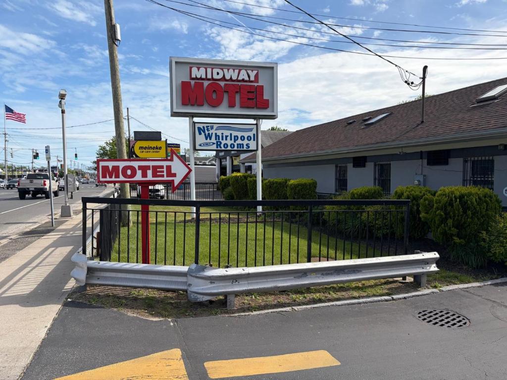 a motel sign on the side of a street at Midway Motel in Patchogue