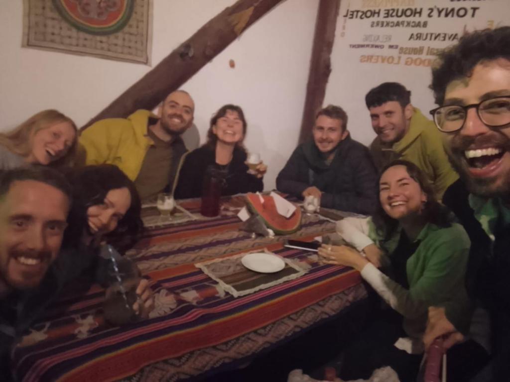 a group of people sitting around a table at Tony's House Eco Hostel in Huaraz