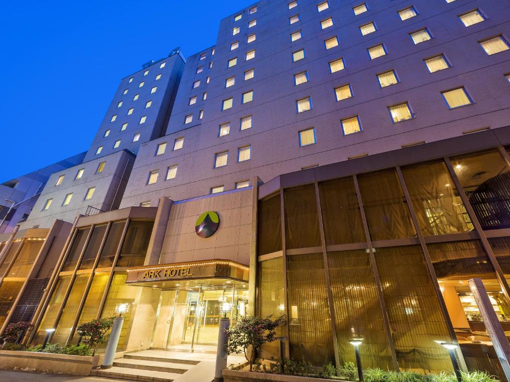 
a large building with a clock on the front of it at Ark Hotel Osaka Shinsaibashi -ROUTE INN HOTELS- in Osaka
