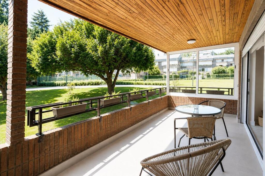 a patio with a table and chairs on a brick wall at Hondarribia con Piscinas, Terraza Privada, Parking y Tenis - CASA OLABIDE in Hondarribia