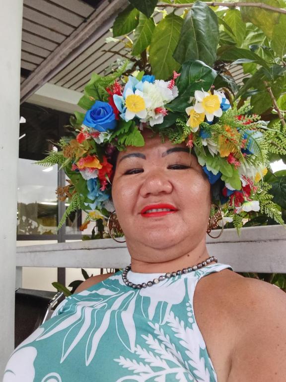 a woman wearing areath of flowers on her head at TEMATAOAVEA Dortoir in Fare