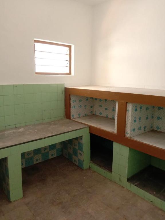 an empty room with benches and a window at Kailas in Kollam