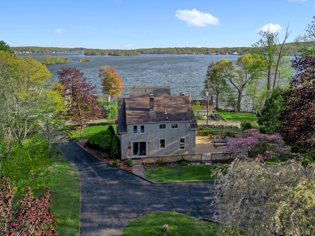 an aerial view of an old house on the water at Grammy's Famous Lake House Retreat in East Hampton