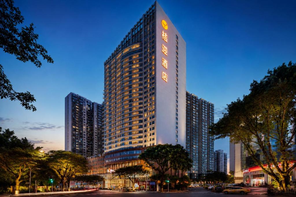 a tall building with a sign on the side of it at JOYINN HOTEL Guangzhou Zoo Shaheding Metro Branch & Guangzhou Beijing Road Pedestrian Street & Canton Fair Nearby 桔迎酒店-广州动物园沙河顶地铁站店 in Guangzhou