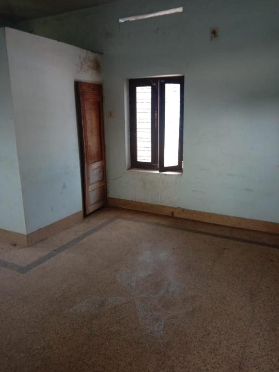 an empty room with a window and a door at Kailas in Kollam
