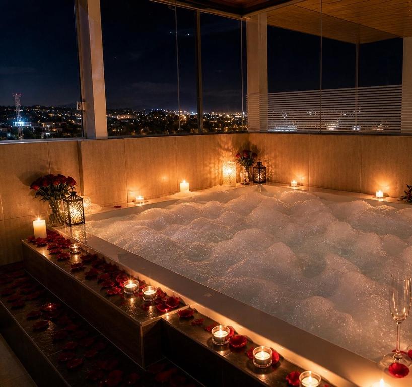 a jacuzzi tub in a building with candles at Tarija Premium Stay Apartamento Premium in Tarija