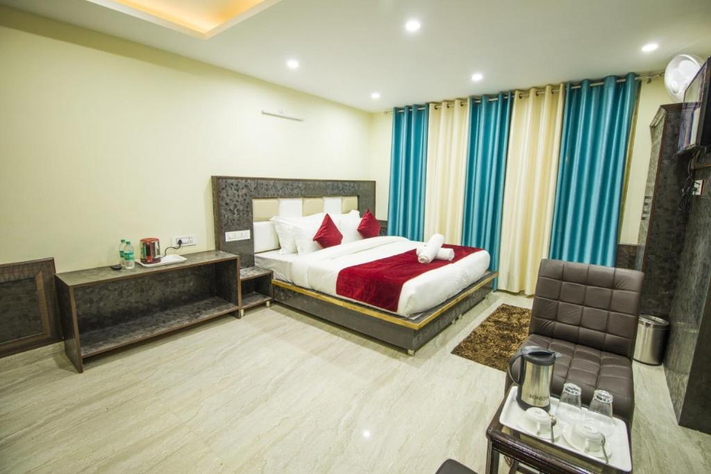 a bedroom with a bed and a chair in a room at Mountain Mount view # triund track 2 km#Free Parking-cricket stadium 8 km-Mcleodganj 2 km in Dharamshala