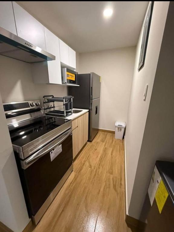 a kitchen with a stove and a refrigerator at Apartamento ignacio in Tegucigalpa