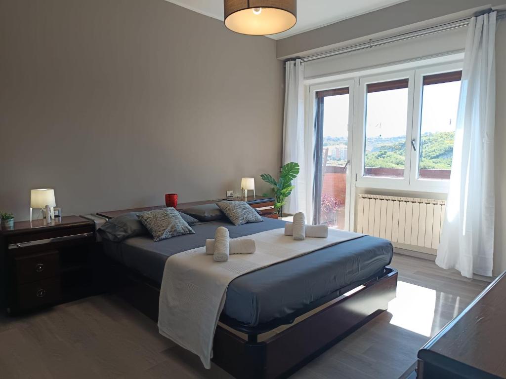 a bedroom with a bed and a large window at Appartamento Turistico Monterotondo in Monterotondo