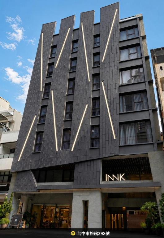 a tall black building with lights on it at Innk in Taichung