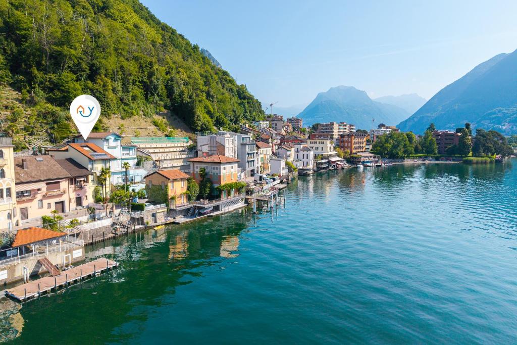 an aerial view of a town next to a river at Casa Tamè - Happy Rentals in Melide