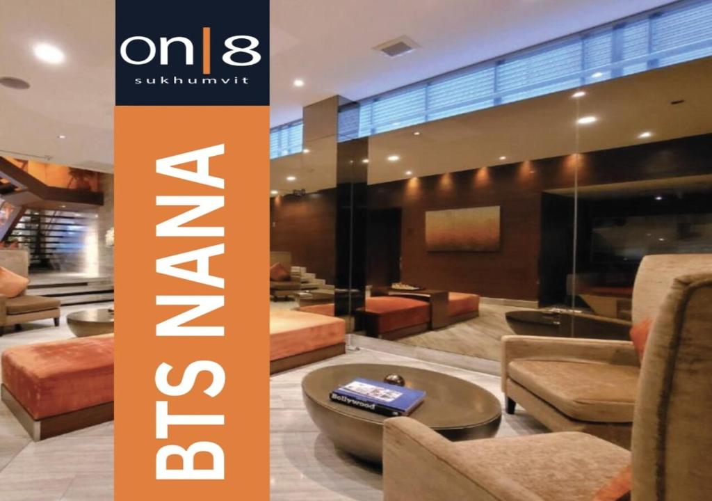 a sign for a lobby with chairs and a table at Aspira On 8 Sukhumvit BTS Nana in Bangkok