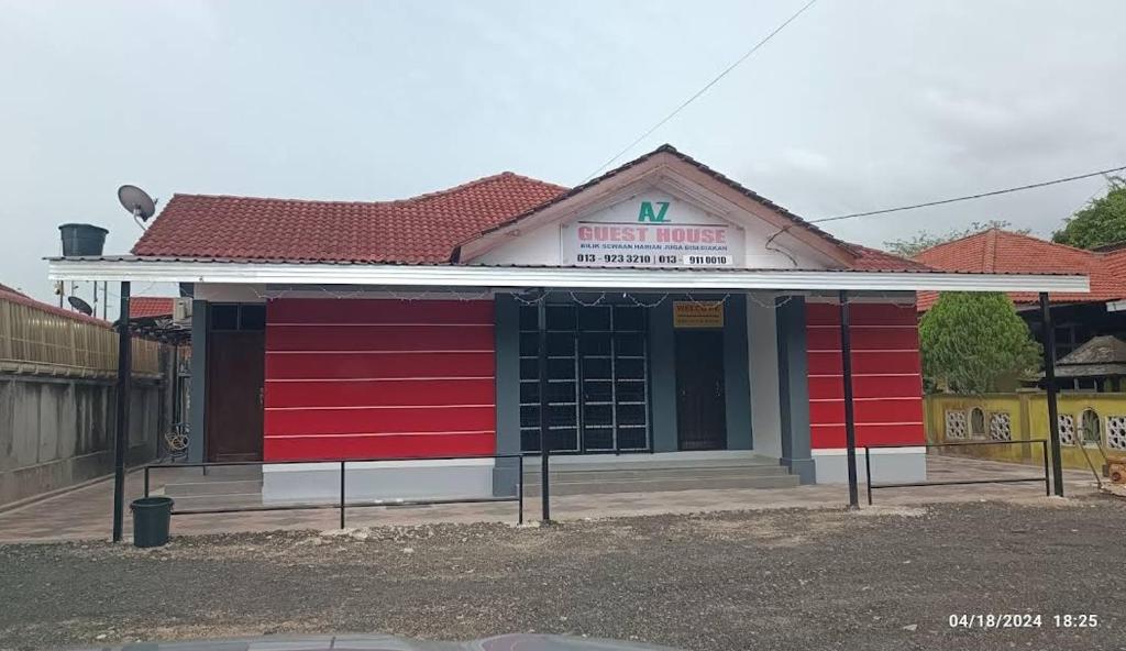 a red and white building with a pharmacy at AZ Guest House & Inn in Pasir Mas