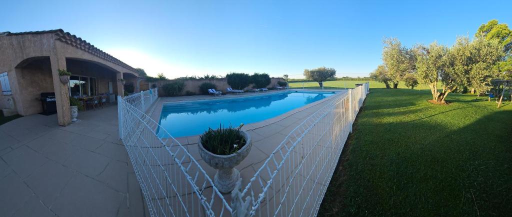 a fence around a swimming pool in a yard at Mas Saint Jean in Arles