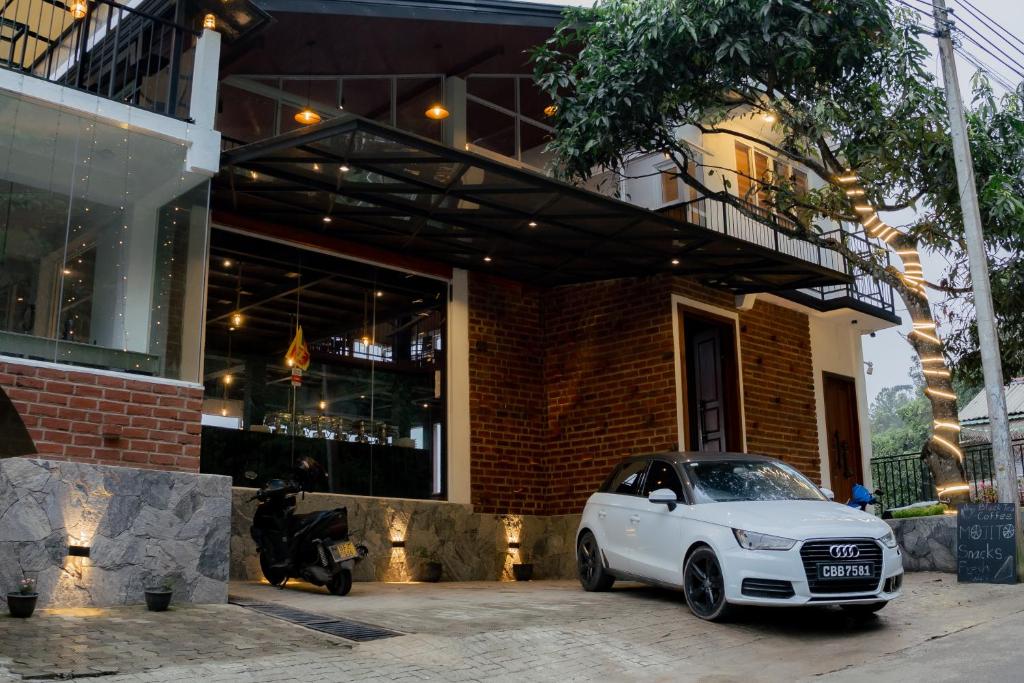 a white car parked in front of a building at Ivory Canopy Resort - Ella in Ella
