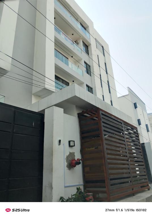 a building with a large wooden door in front of it at Vineyardcourts Apartment in Lagos