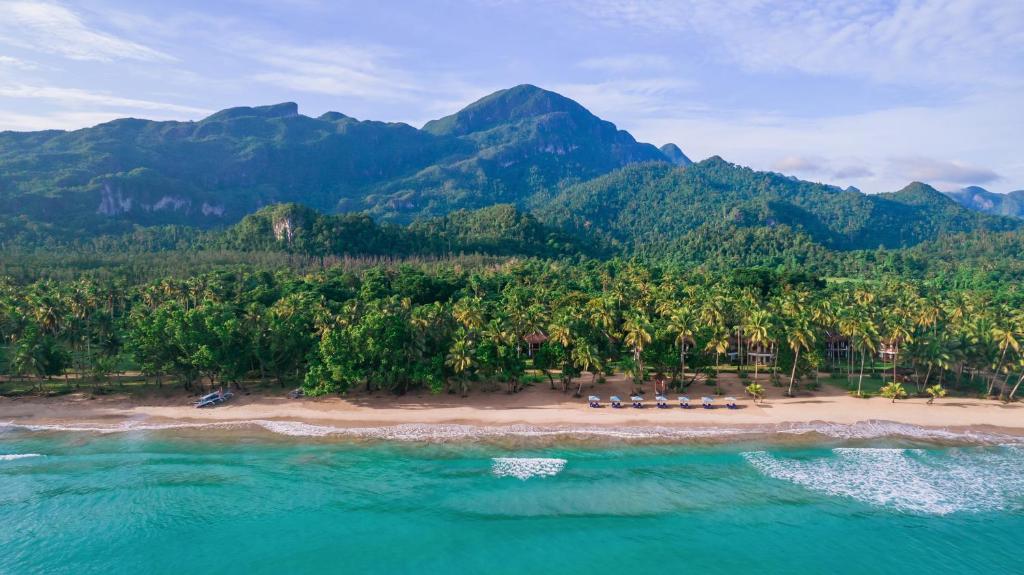 an island with a group of people on a beach at Daluyon Beach and Mountain Resort in Sabang