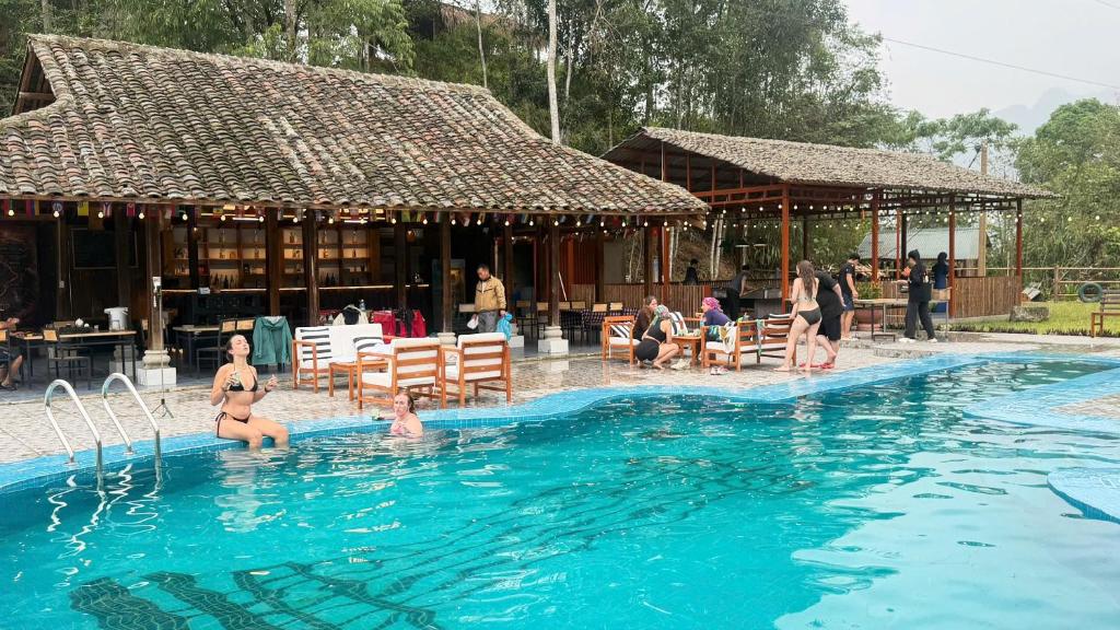 a group of people in a swimming pool at Loop Tribe - Social Hostel in Ha Giang