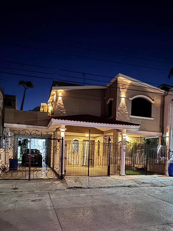 a house with a gate at night with lights at Casa Luna in Ciudad Madero