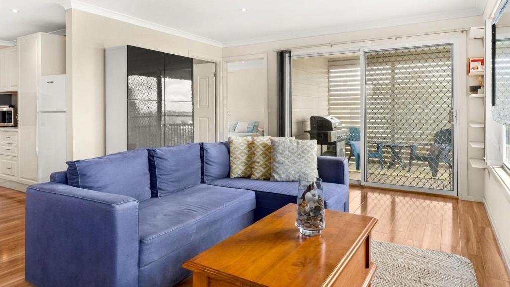 a blue couch in a living room with a table at Bayview Unit in Surf Beach