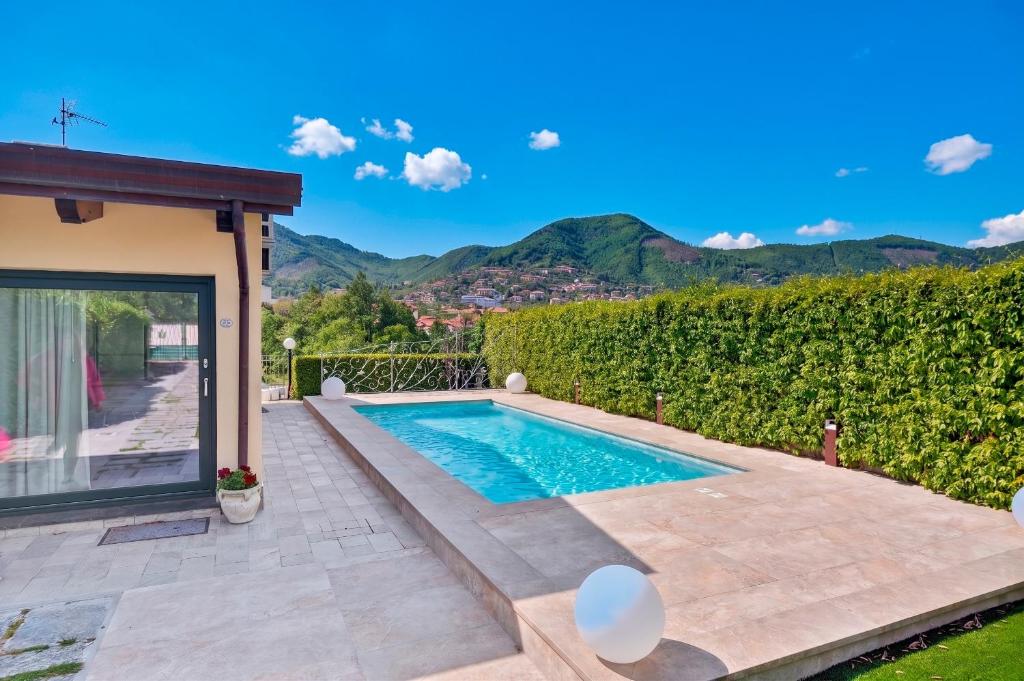a swimming pool in the backyard of a house at Villa Degli Dei in Agerola