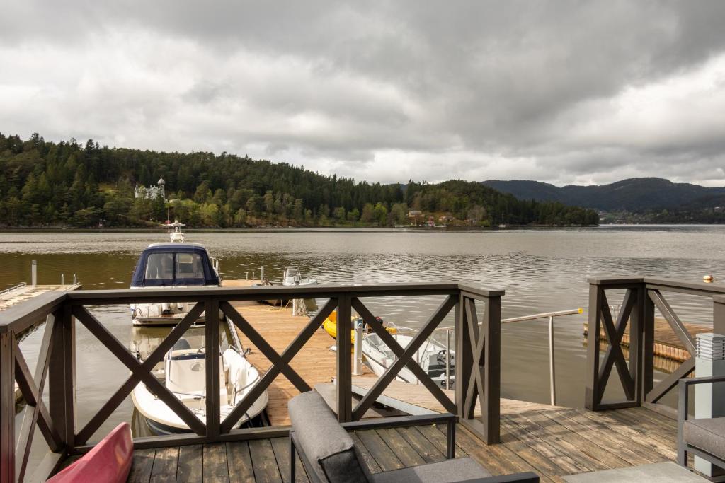 a dock with two boats on the water at Villa Oleanna in Lysekloster
