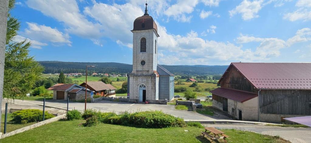 a small white church with a tall tower at Chez Rinner in Gellin