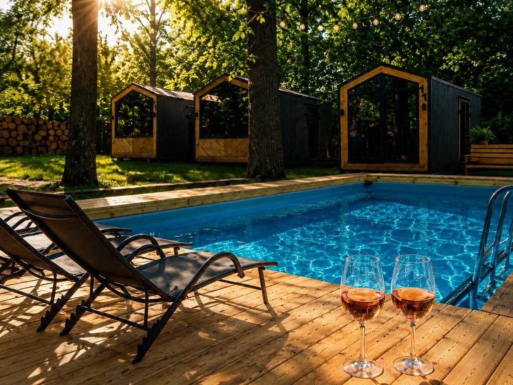 two glasses of wine sitting next to a swimming pool at SmartVille Kyiv in Kyiv