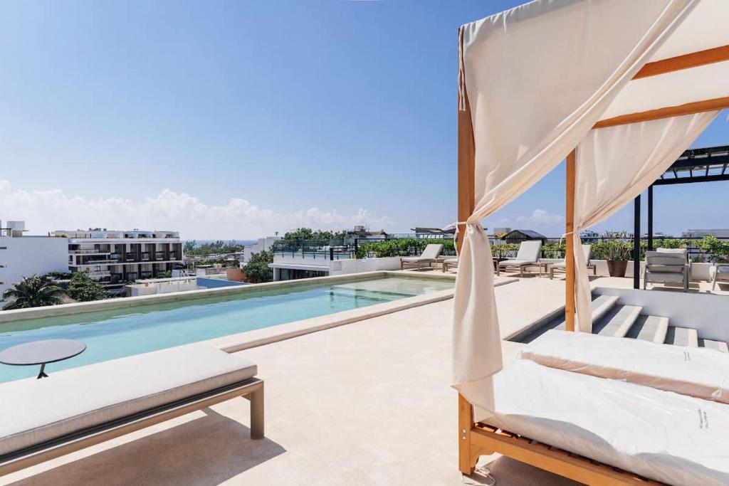 a view of a swimming pool from the balcony of a house at Beautiful apartment Top location! in Playa del Carmen
