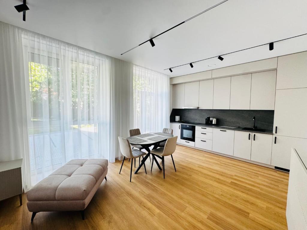 a kitchen and dining room with a table and chairs at Apartment in the city center near park and river 5 in Marijampolė